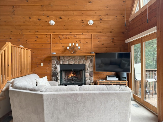 living room with a fireplace, carpet floors, vaulted ceiling, and wooden walls