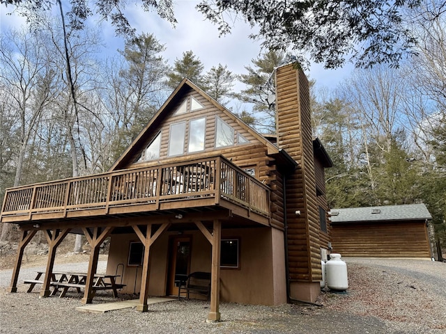 back of house featuring a wooden deck