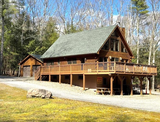 view of front of house featuring a garage and a deck