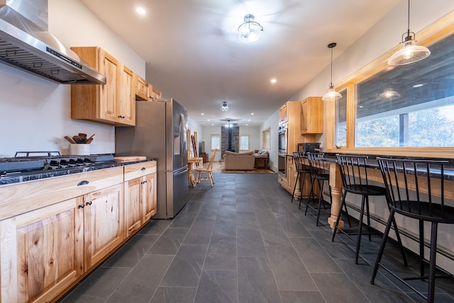 kitchen featuring pendant lighting, light brown cabinets, stainless steel appliances, and exhaust hood