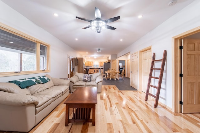 living room featuring ceiling fan and light wood-type flooring