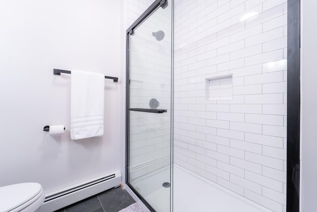 bathroom with tile patterned flooring, a baseboard radiator, a shower with shower door, and toilet