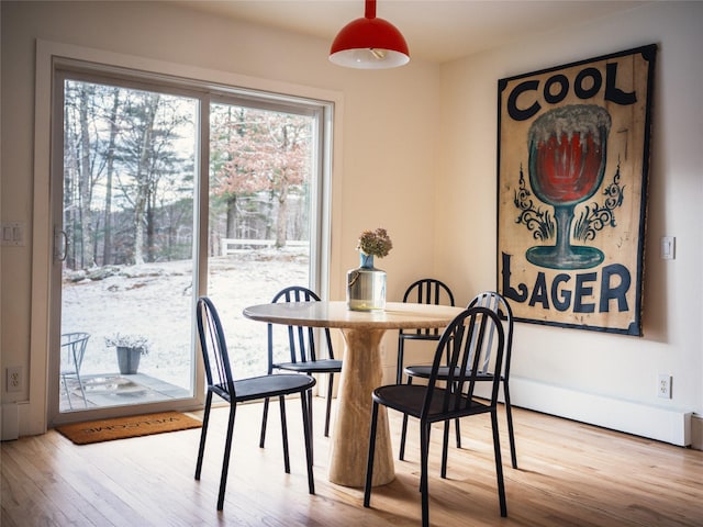 dining space with light hardwood / wood-style floors