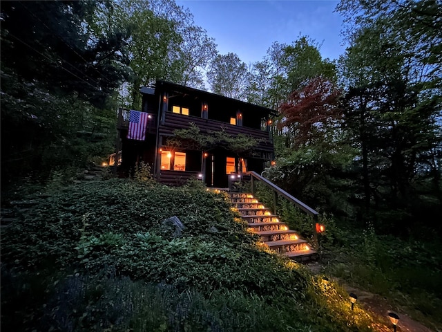 rear view of property with stairs