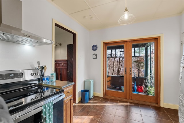 doorway to outside featuring french doors, dark tile patterned floors, and baseboards