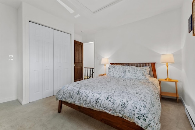 bedroom featuring a closet, light colored carpet, and baseboards