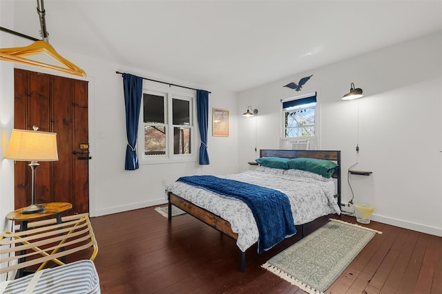 bedroom featuring dark wood-style flooring and baseboards