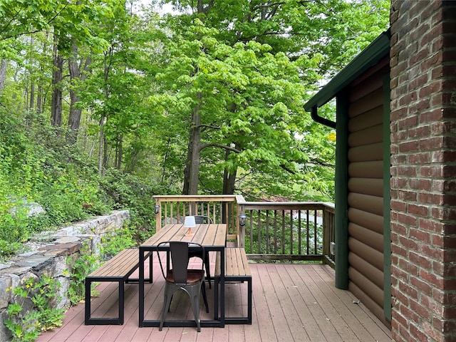 wooden deck featuring outdoor dining area