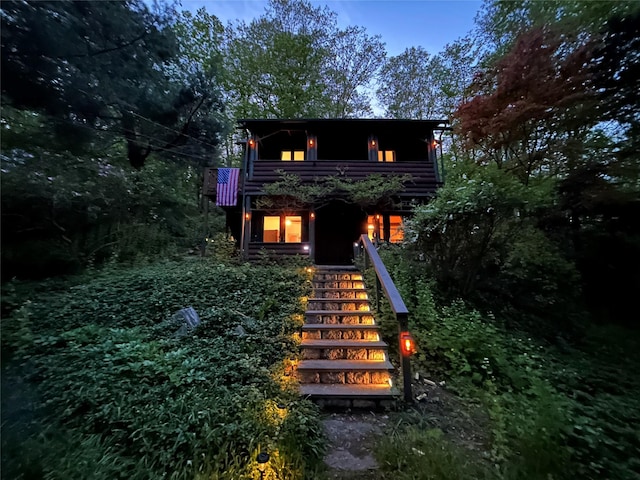 back of property at dusk with stairway