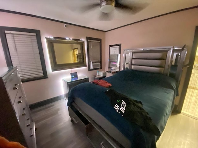 bedroom with ceiling fan, dark hardwood / wood-style floors, and ornamental molding