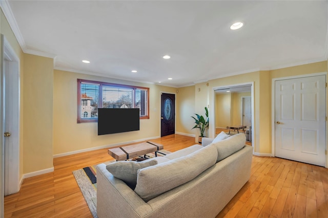 living room with light hardwood / wood-style floors and crown molding