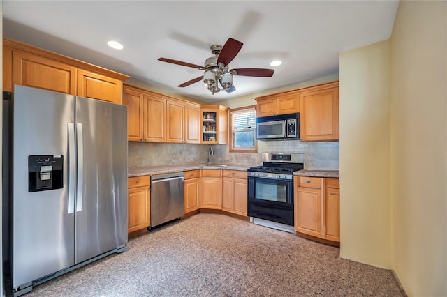 kitchen featuring stainless steel appliances, ceiling fan, tasteful backsplash, and sink