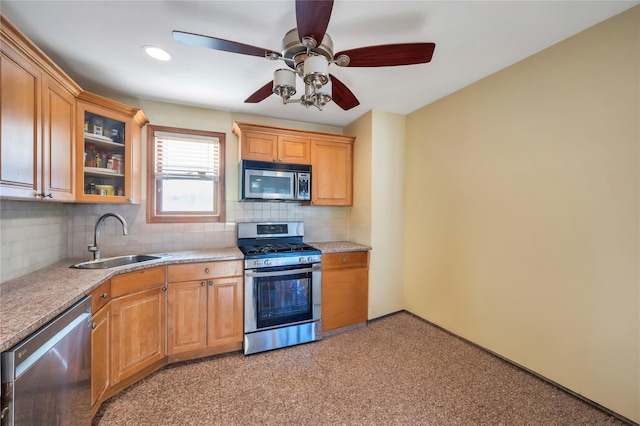 kitchen with sink, stainless steel appliances, backsplash, and ceiling fan