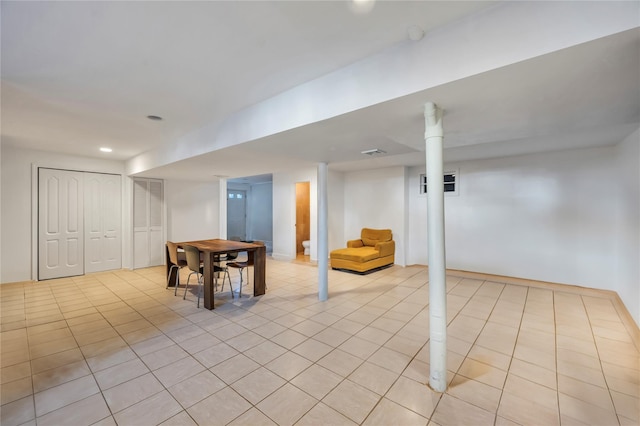 basement featuring light tile patterned floors