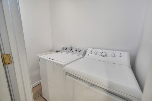 washroom with separate washer and dryer and light tile patterned flooring