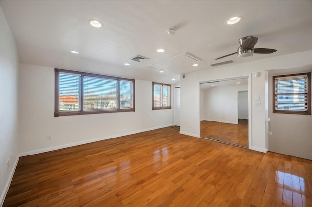 spare room with hardwood / wood-style floors and ceiling fan