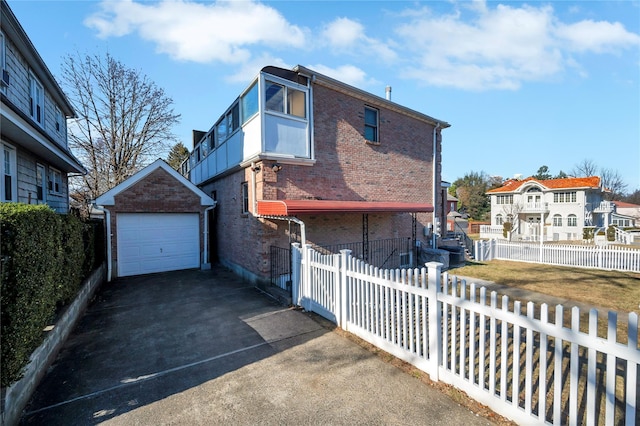 view of front of property featuring a garage and an outdoor structure