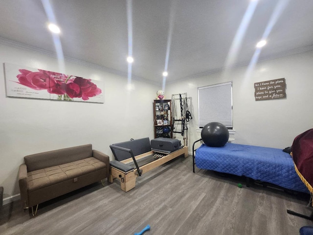 bedroom featuring hardwood / wood-style floors and ornamental molding