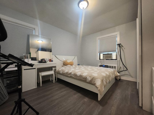 bedroom featuring dark hardwood / wood-style floors and cooling unit