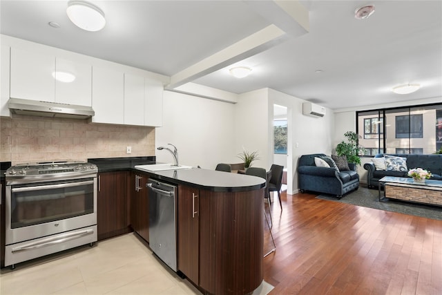 kitchen with sink, dark brown cabinets, white cabinetry, stainless steel appliances, and extractor fan