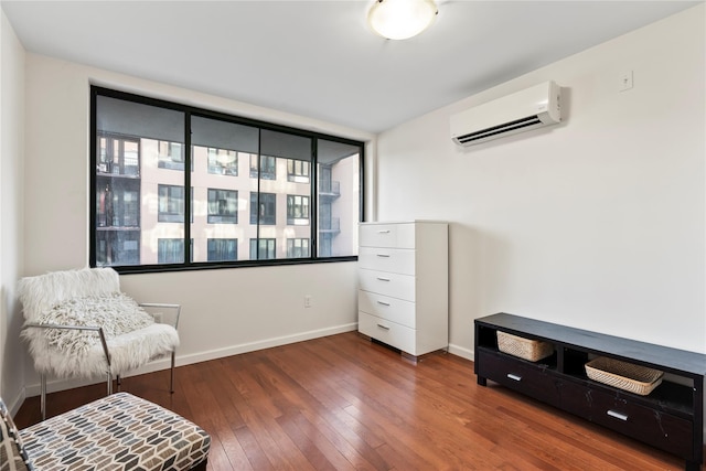 living area featuring dark hardwood / wood-style flooring and an AC wall unit