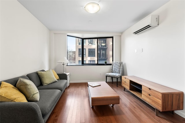 living room with a wall mounted air conditioner and dark hardwood / wood-style flooring