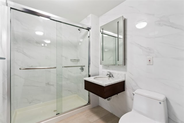 bathroom featuring toilet, an enclosed shower, sink, and tile walls