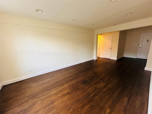 unfurnished room featuring dark hardwood / wood-style flooring