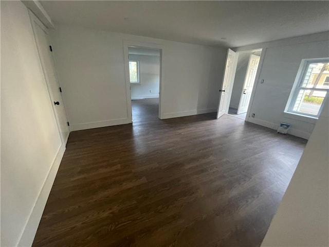 unfurnished room featuring dark wood-type flooring