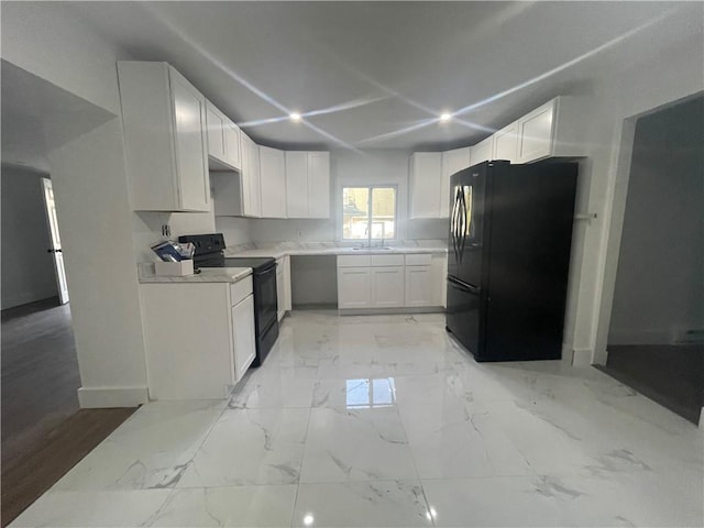 kitchen featuring black appliances, white cabinets, and sink