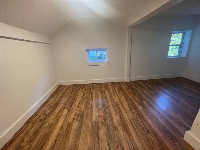 bonus room featuring dark hardwood / wood-style floors and vaulted ceiling