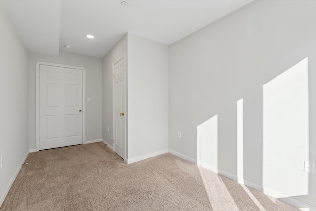 empty room featuring light carpet