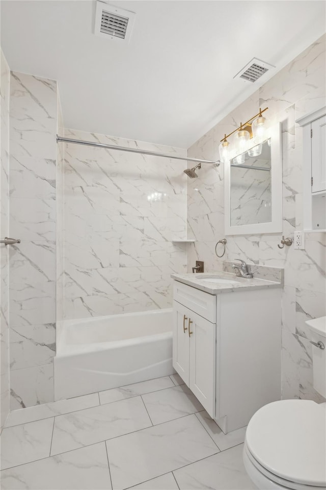 full bathroom featuring toilet, tiled shower / bath, and vanity