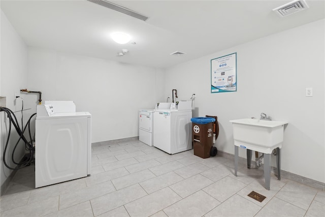 washroom featuring light tile patterned flooring and independent washer and dryer