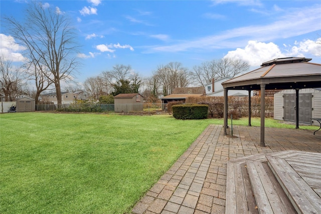 view of yard with a shed, a gazebo, and a patio