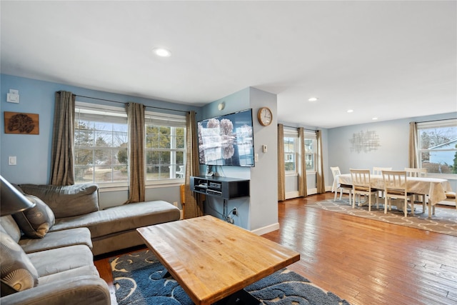 living room featuring plenty of natural light and light hardwood / wood-style floors