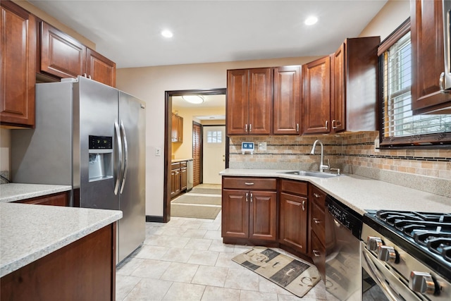 kitchen featuring decorative backsplash, sink, light tile patterned floors, and stainless steel appliances