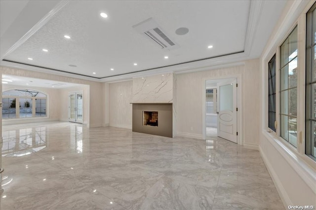 unfurnished living room with a healthy amount of sunlight, crown molding, and a high end fireplace