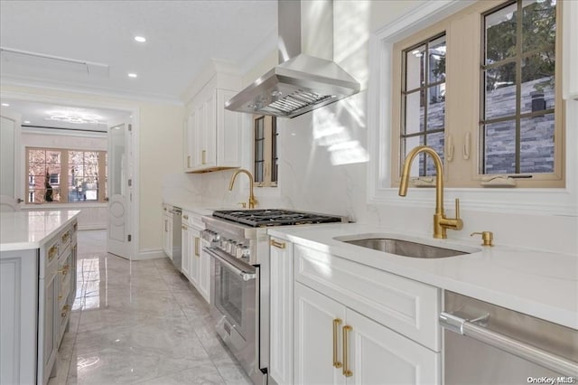 kitchen featuring ornamental molding, island range hood, stainless steel appliances, sink, and white cabinetry