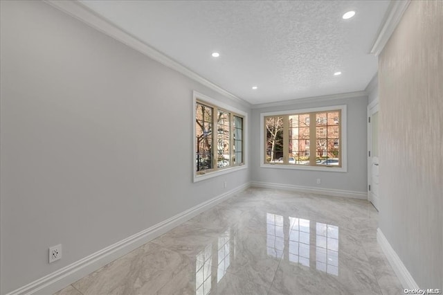 spare room featuring crown molding and a textured ceiling