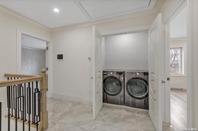 clothes washing area featuring washer and clothes dryer and ornamental molding