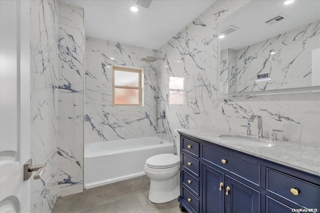 full bathroom featuring vanity, toilet, and tiled shower / bath