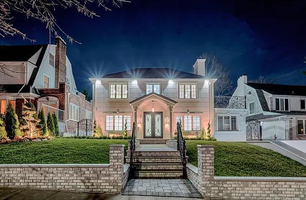 view of front of home with a yard and french doors