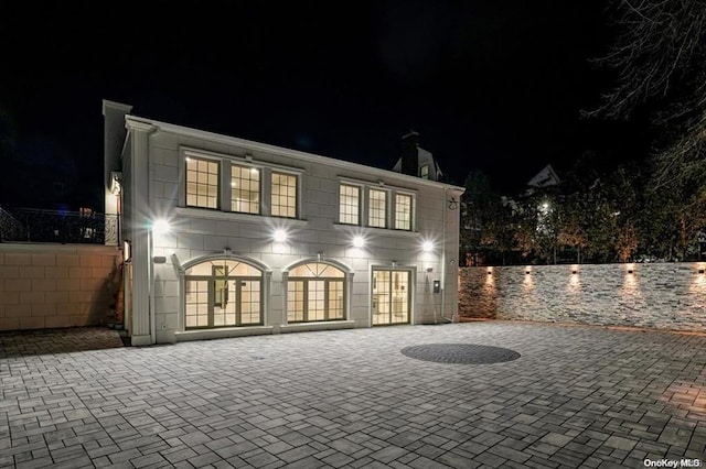 back house at twilight with french doors