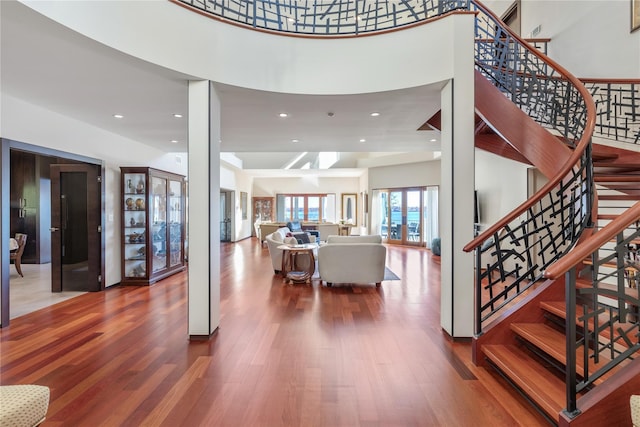 entryway with a high ceiling and hardwood / wood-style flooring