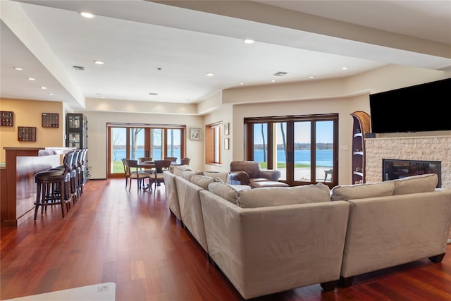 living room featuring dark hardwood / wood-style flooring and a fireplace