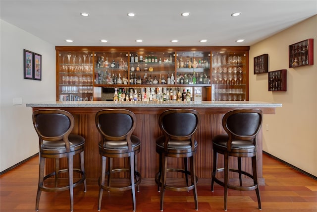 bar featuring hardwood / wood-style flooring