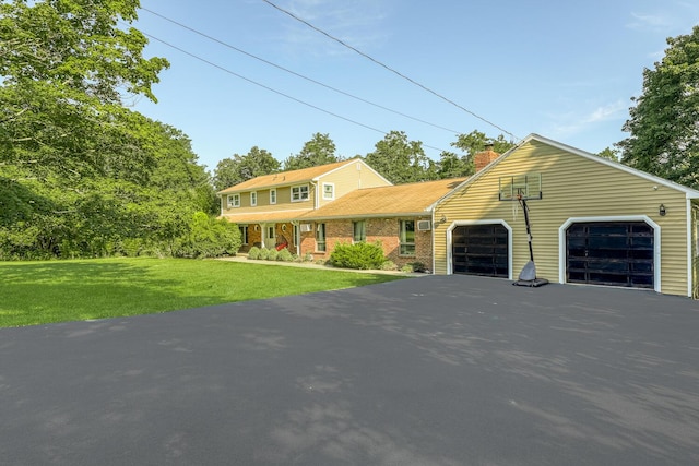 view of front of home featuring a front yard, a porch, and a garage