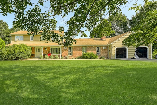 view of front of house with a front yard and a garage