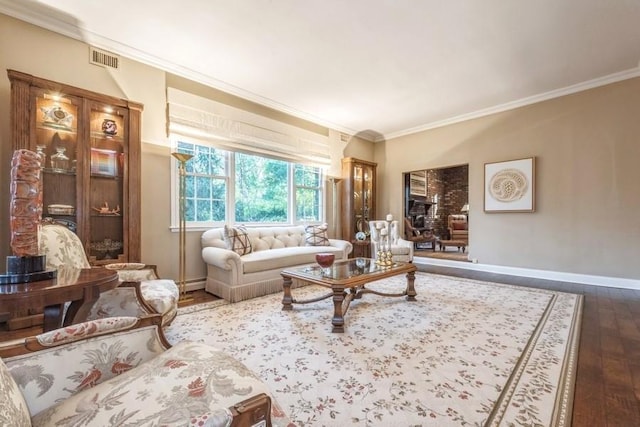 living room featuring hardwood / wood-style floors, crown molding, and baseboard heating